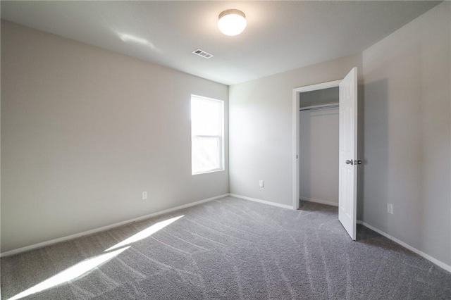 unfurnished bedroom with dark carpet