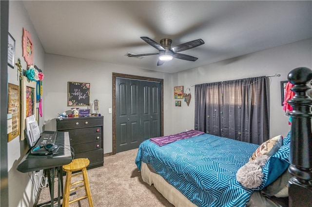 bedroom with a ceiling fan, a closet, and light colored carpet