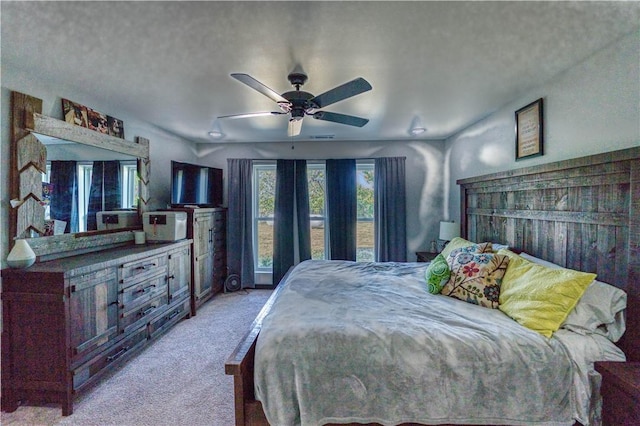 bedroom featuring light carpet and a ceiling fan