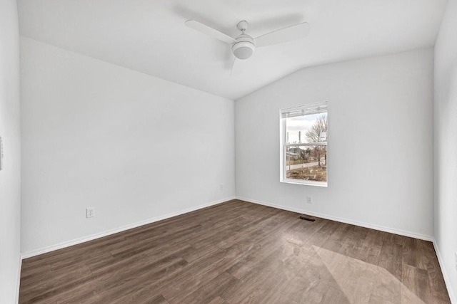 empty room with visible vents, ceiling fan, baseboards, lofted ceiling, and wood finished floors