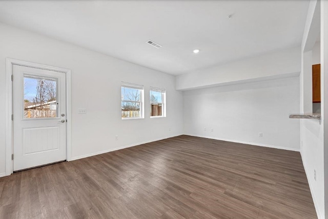 interior space with recessed lighting, visible vents, baseboards, and wood finished floors