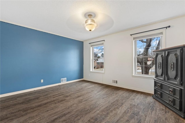 unfurnished bedroom featuring ceiling fan and dark wood-type flooring