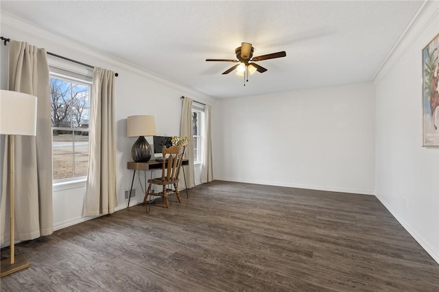 empty room featuring a wealth of natural light, crown molding, ceiling fan, and dark wood-type flooring