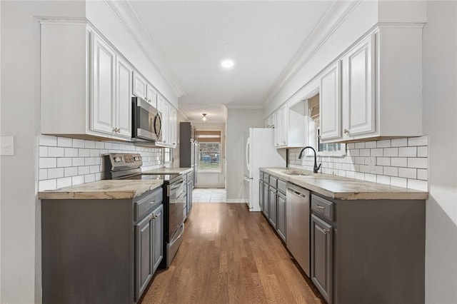 kitchen with white cabinets, appliances with stainless steel finishes, butcher block countertops, and sink