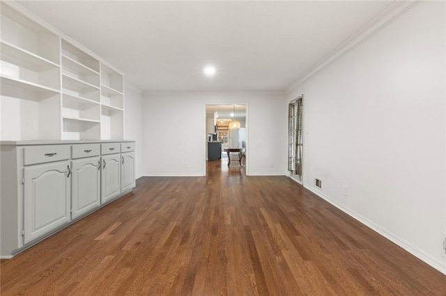 unfurnished living room featuring dark wood-type flooring and crown molding