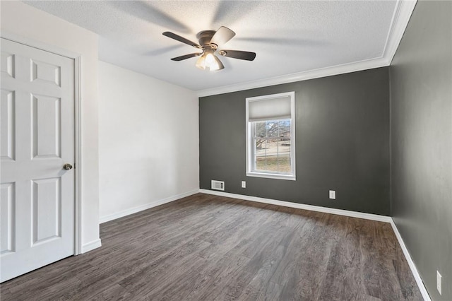 empty room with ornamental molding, a textured ceiling, ceiling fan, and dark wood-type flooring