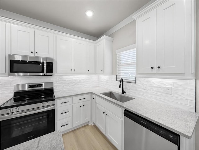 kitchen with sink, white cabinets, and stainless steel appliances