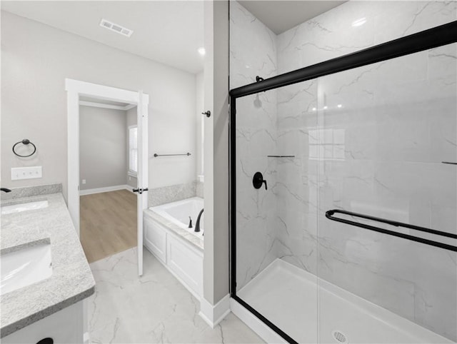 bathroom with vanity and independent shower and bath