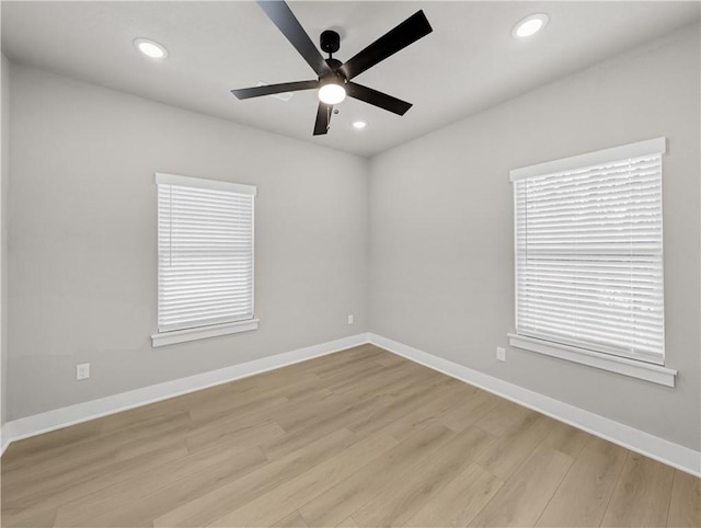 empty room featuring ceiling fan and light hardwood / wood-style floors