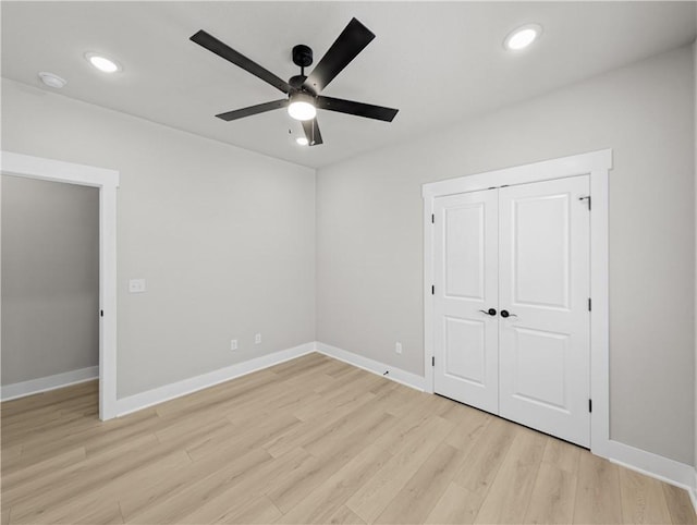 unfurnished bedroom with a closet, ceiling fan, and light hardwood / wood-style flooring