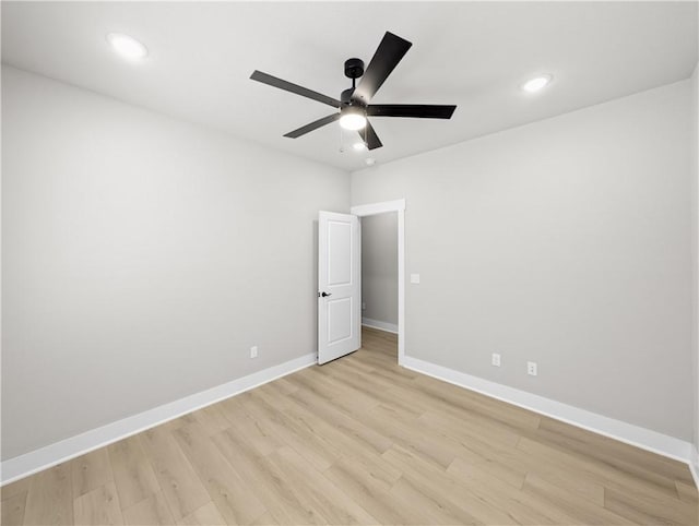 spare room featuring ceiling fan and light hardwood / wood-style flooring