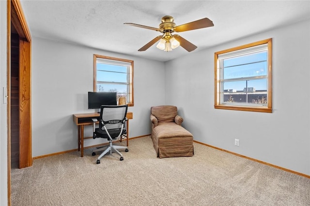 office area with light carpet and ceiling fan