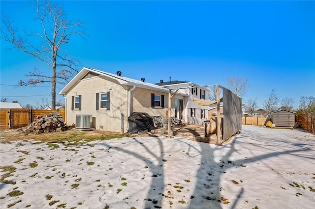 back of property with central AC and a storage unit