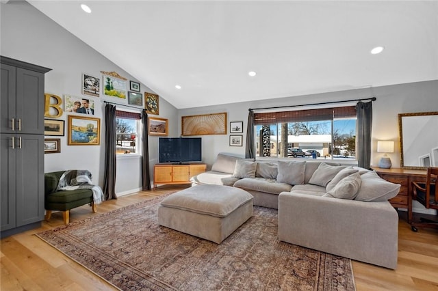 living room featuring light hardwood / wood-style flooring and lofted ceiling