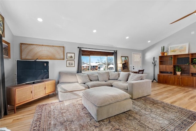 living room featuring light wood-type flooring and lofted ceiling