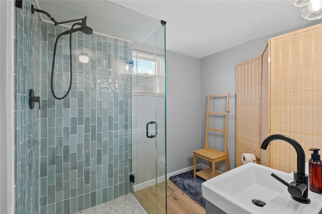 bathroom with wood-type flooring, sink, and walk in shower