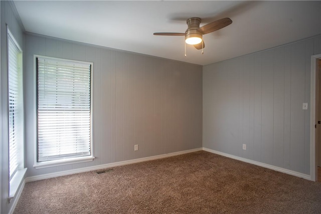 spare room featuring carpet floors and ceiling fan