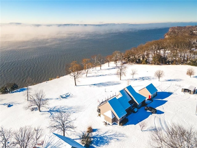 snowy aerial view featuring a water view