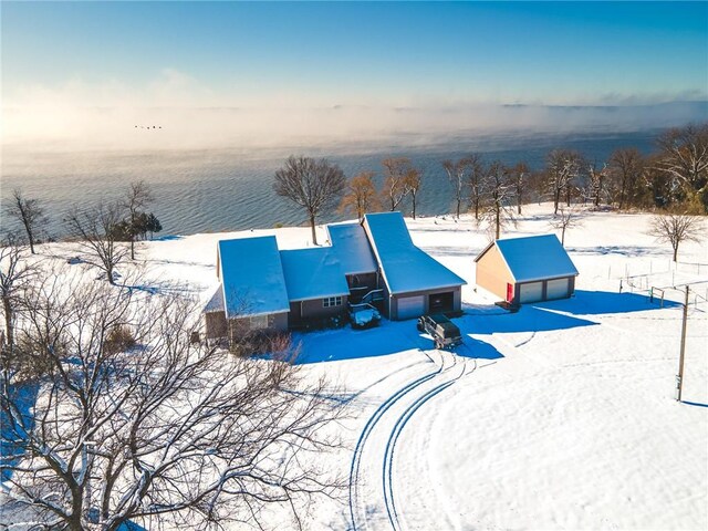 snowy aerial view with a water view