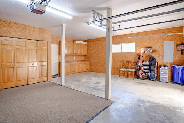 garage featuring a garage door opener and electric panel