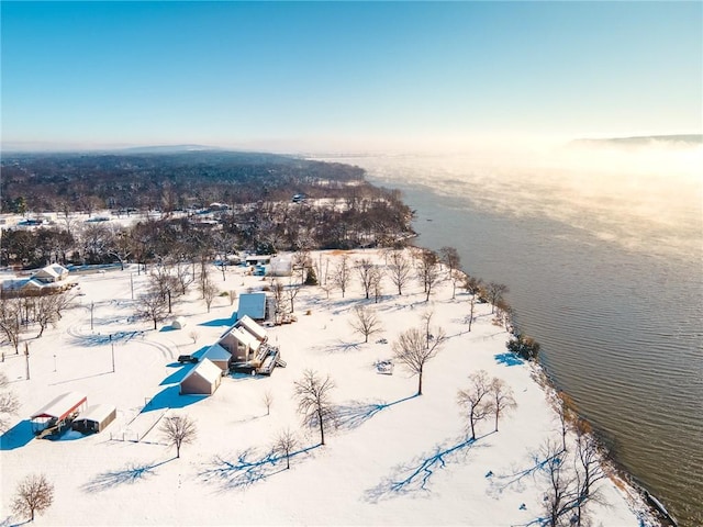 snowy aerial view with a water view