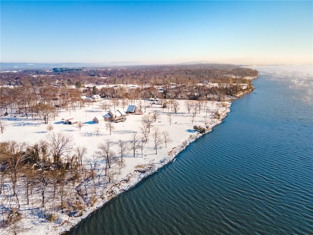 snowy aerial view featuring a water view