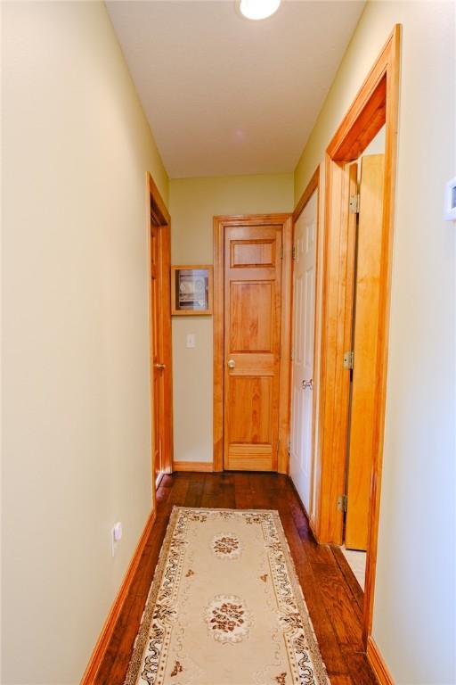 hallway with dark wood-type flooring