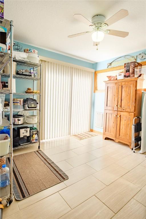 interior space featuring ceiling fan