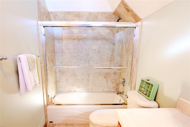 full bathroom featuring toilet, combined bath / shower with glass door, and vanity