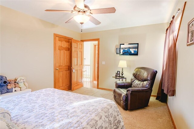 bedroom with ceiling fan and light carpet