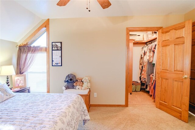 bedroom featuring vaulted ceiling, light colored carpet, ceiling fan, and a closet