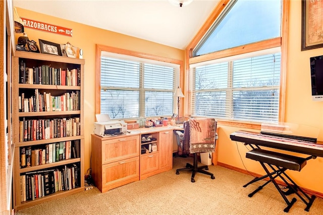 office area with lofted ceiling, a healthy amount of sunlight, and light colored carpet