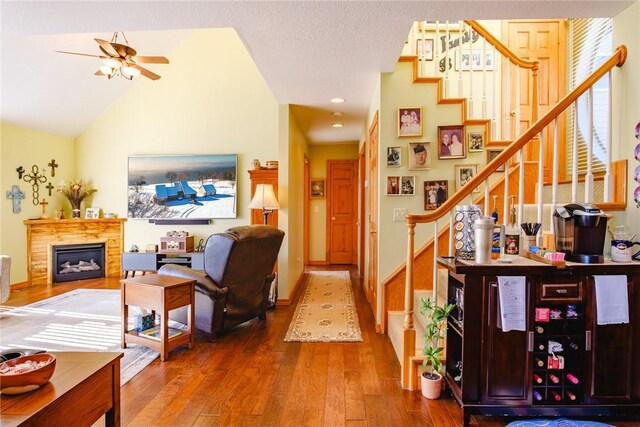 interior space with vaulted ceiling, ceiling fan, and wood-type flooring