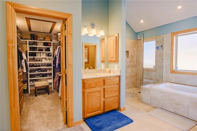 bathroom featuring shower with separate bathtub and vanity