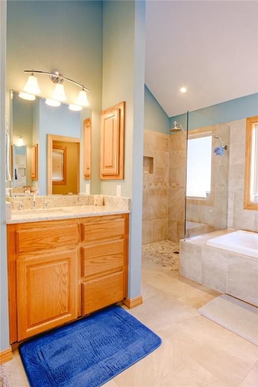 bathroom with vanity, tile patterned floors, and independent shower and bath