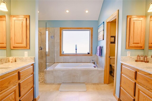 full bathroom featuring independent shower and bath, tile patterned flooring, vanity, and toilet