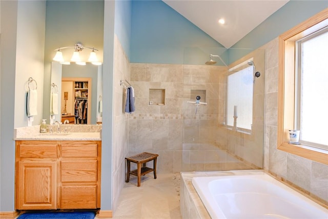 bathroom featuring plus walk in shower and vanity