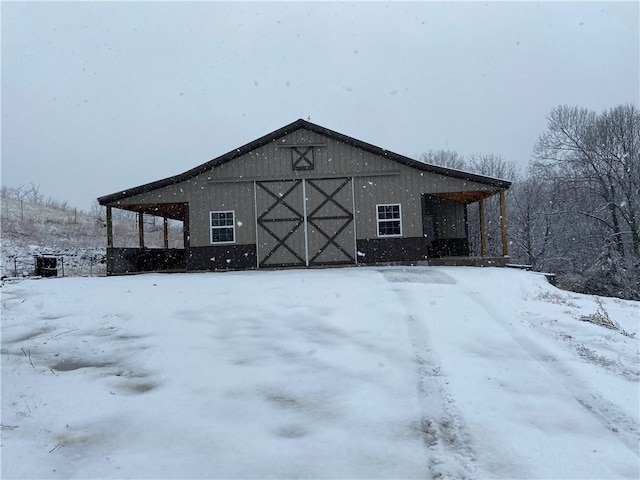 view of snow covered rear of property