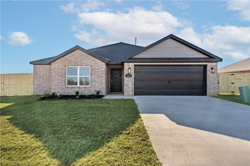 ranch-style home with a front yard and a garage