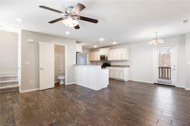 kitchen with stainless steel appliances, pendant lighting, dark hardwood / wood-style floors, white cabinetry, and ceiling fan with notable chandelier