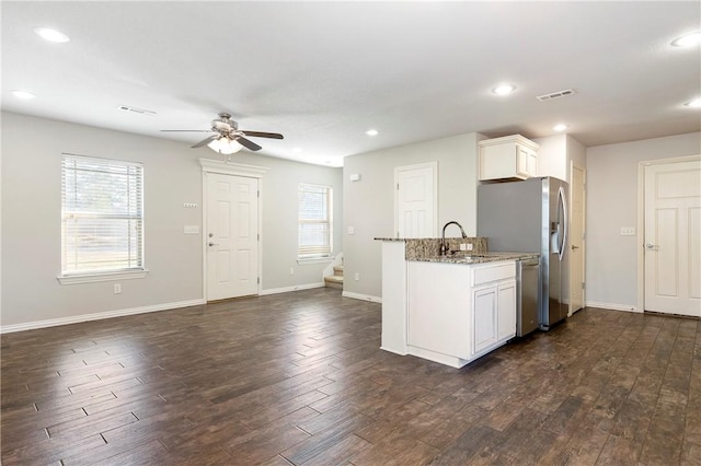 kitchen featuring light stone countertops, ceiling fan, dark hardwood / wood-style flooring, white cabinets, and sink