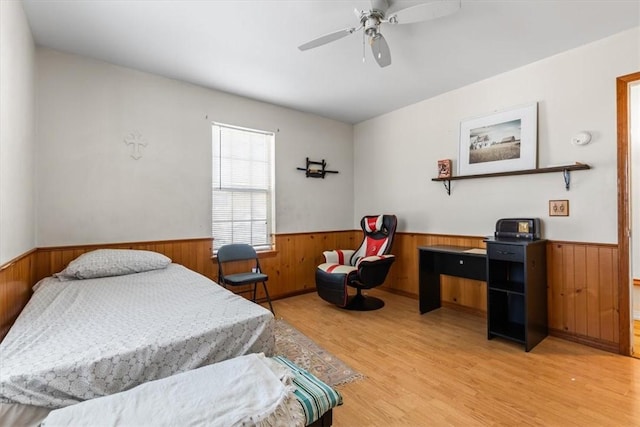 bedroom with ceiling fan and light hardwood / wood-style flooring