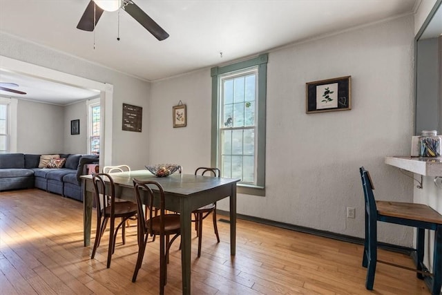 dining room featuring light hardwood / wood-style floors, ceiling fan, and crown molding