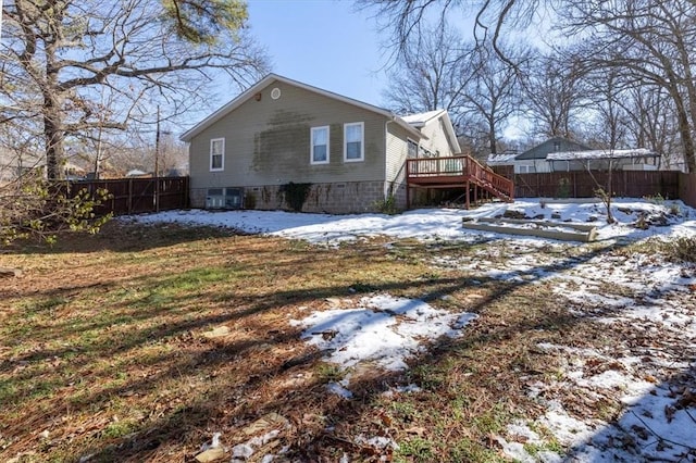 snow covered house featuring a deck