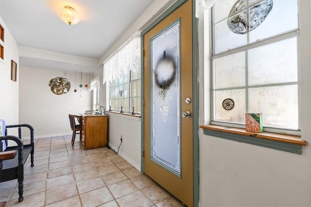 doorway to outside with light tile patterned flooring