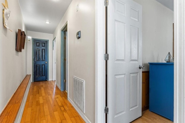 hallway with hardwood / wood-style floors