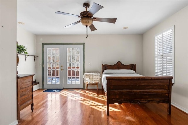 bedroom with ceiling fan, french doors, access to outside, and hardwood / wood-style floors