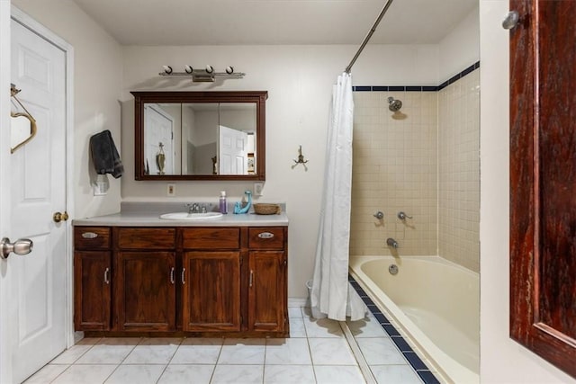 bathroom featuring tile patterned flooring, shower / bath combo, and vanity