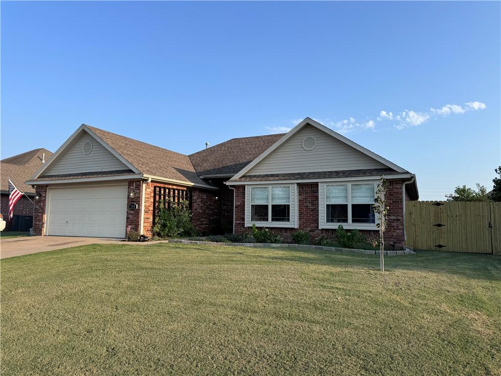 ranch-style home with a front yard and a garage