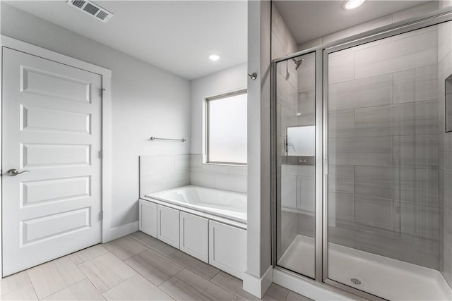 bathroom with separate shower and tub